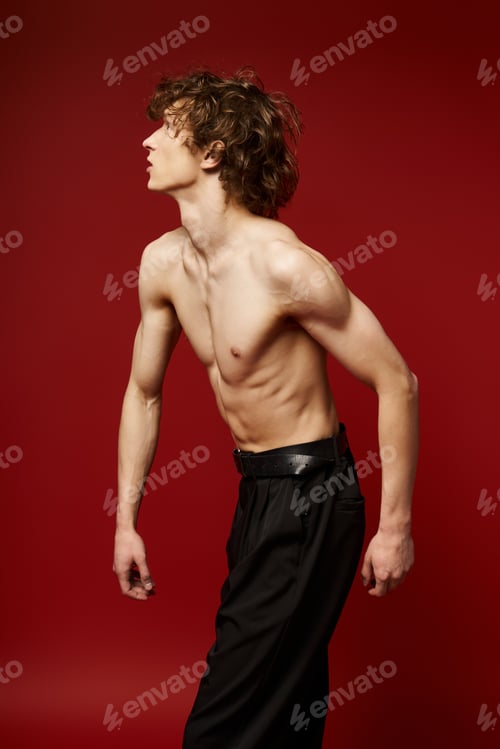 Preview: Curly-haired dancer showcases his talent in a vibrant red dance studio backdrop