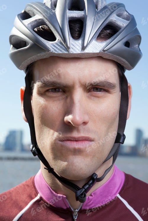 Preview: Cyclist poised for a ride with a cityscape behind him.