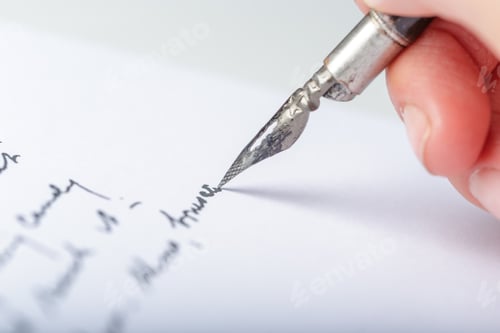 Preview: Writing with a fountain pen on paper in a close-up view during daylight hours