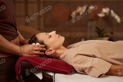 Preview: Patient dozing during head massage performed by masseuse
