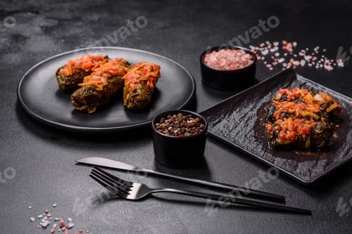 Preview: Dolma, stuffed grape leaves with rice and meat on a dark background