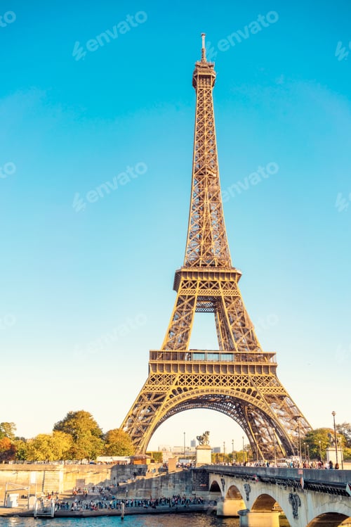 Preview: Majestic view of the Eiffel Tower standing tall against a clear blue sky, with the Seine
