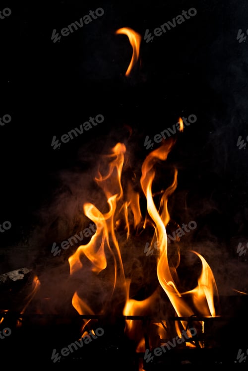 Preview: Flames in the fire of a red and yellow barbecue.