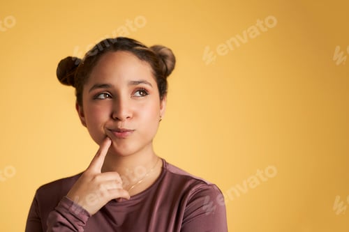 Preview: Young woman touching chin and looking at camera