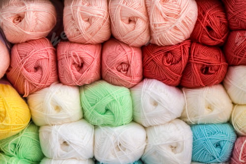 Preview: Close up shot of colored wool yarn balls as background