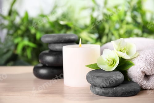 Preview: Composition with spa stones, towel and candle on wooden table, space for text
