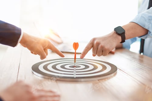 Preview: Men pointing at dartboard at wooden table indoors, closeup