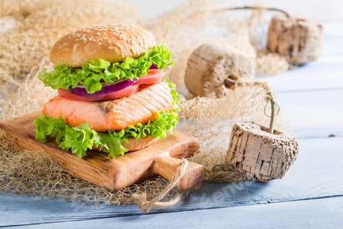 Preview: Tasty sandwich with fish and vegetables on old wooden table