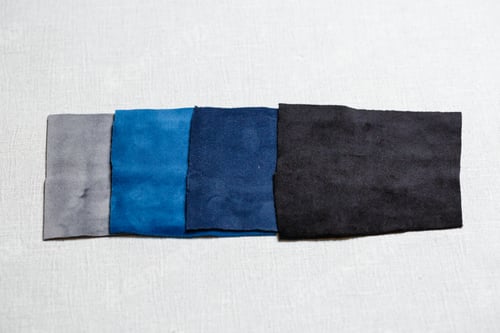 Preview: square pieces of multi-colored fabric laid out on a gray background