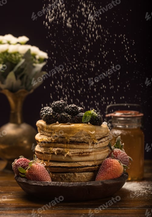 Vista previa: Vertical shot of delicious pancakes with berries on black background