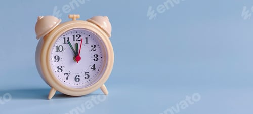 Preview: Alarm Clock Showing Five Minutes to Twelve on Blue Background with Copy Space
