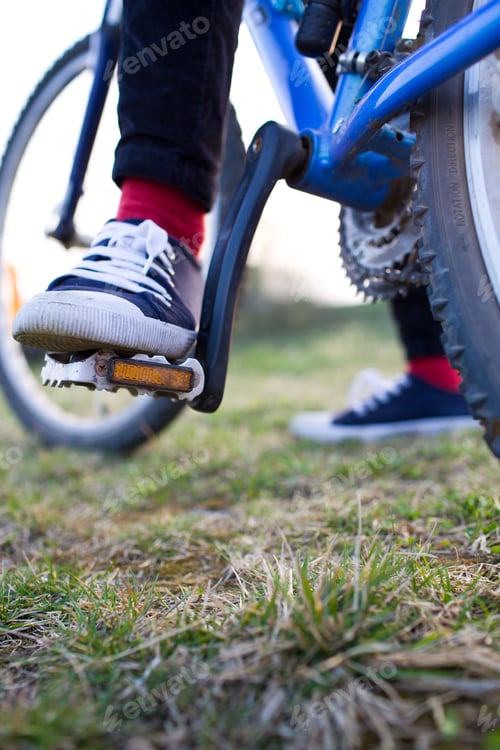 Preview: pretty young female biker outdoors on her mountain bike (shallow