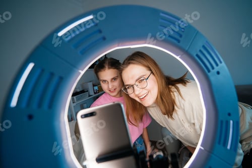 Preview: mother and daughter teenager record video use smartphone