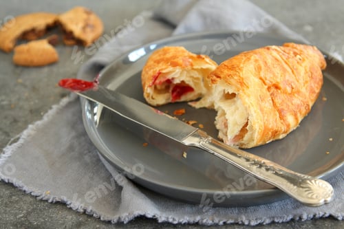 Preview: Croissant with strawberry jam on gray plate