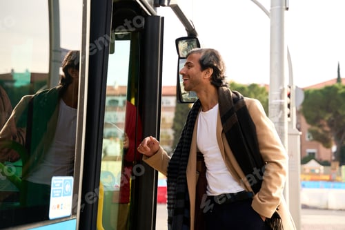 Preview: Stylish man smiling boarding public bus commuting