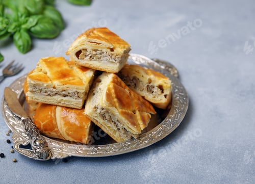 Preview: puff pastry pie with meat on a wooden board