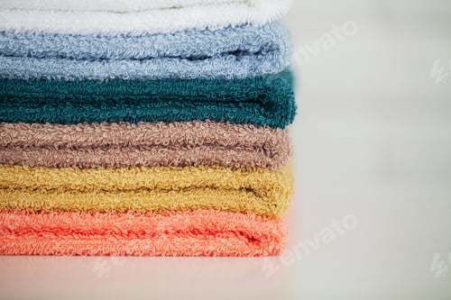 Preview: Colorful cotton towels in bathroom on white wooden table