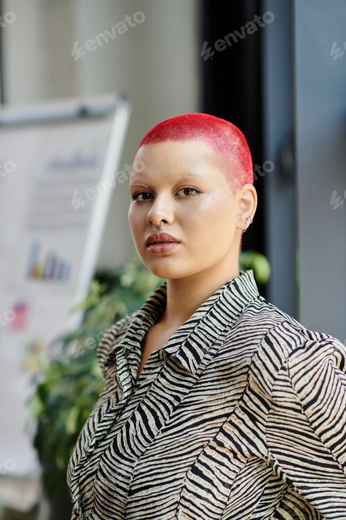 Preview: A confident bald woman with vibrant red hair in a stylish striped outfit at an urban location