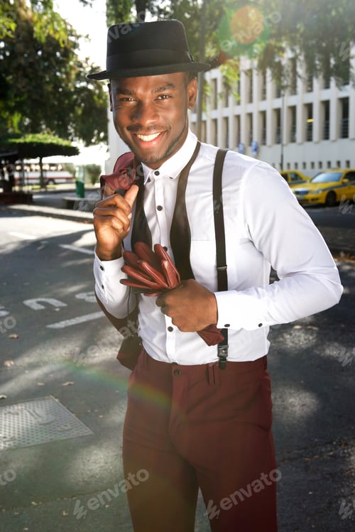Preview: stylish young african american man with vintage suit smiling in city