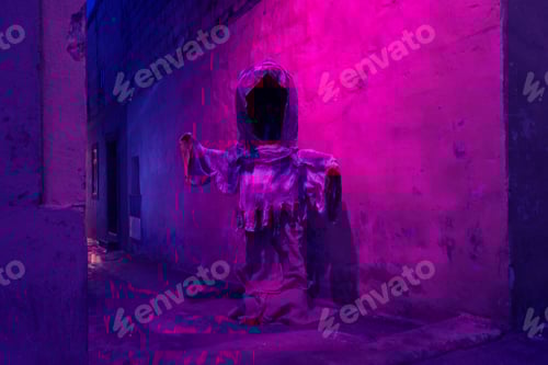 Preview: Silhouette of scary mythical ghost against wall with duotone illuminated colors