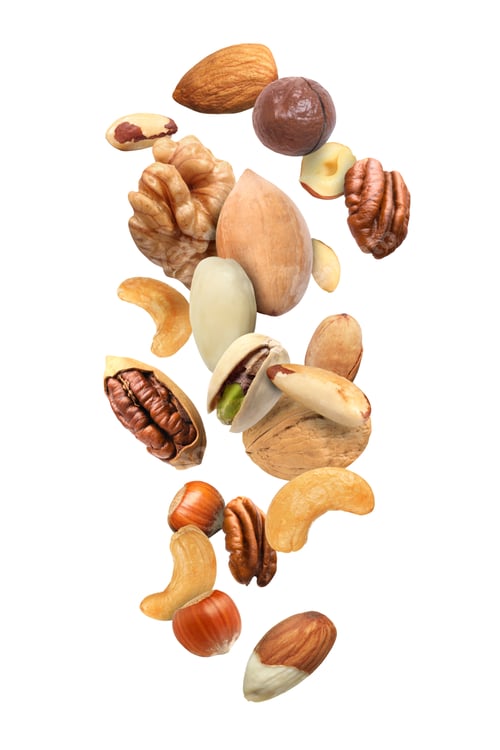 Preview: Pecan and other nuts in air on white background