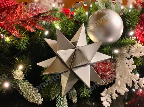 Preview: Close Up of a star ornament on a decorated Christmas tree