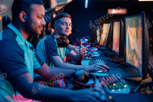 Preview: Young professional esports players playing games in internet cafe