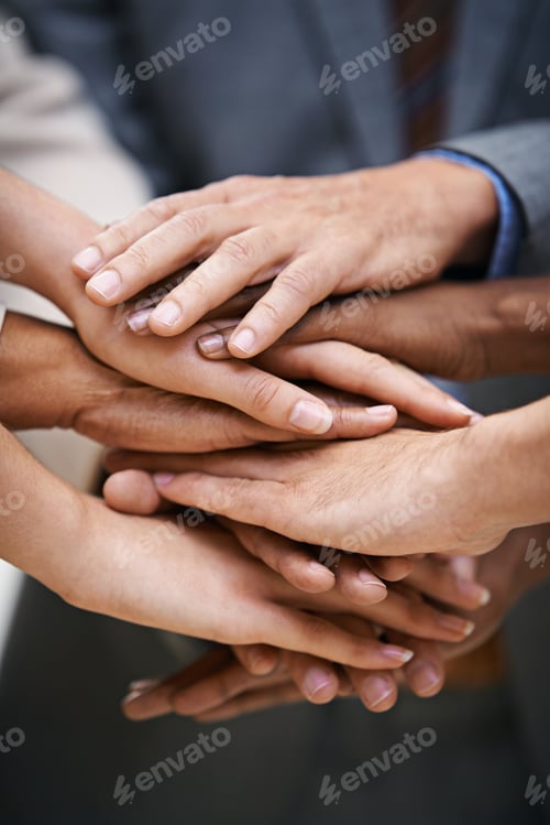 Preview: Shot of a group of businesspeople putting their hands together in unity