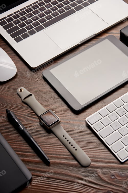Preview: close-up shot of various modern gadgets on wooden table