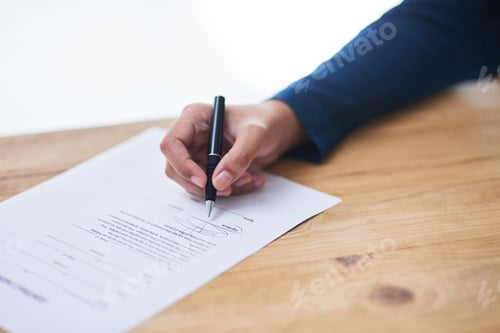 Preview: Signing the deal. Shot of a person signing paperwork.