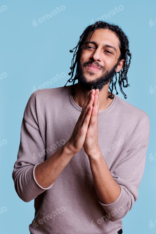 Preview: Smiling arab man pleading with folded arms portrait