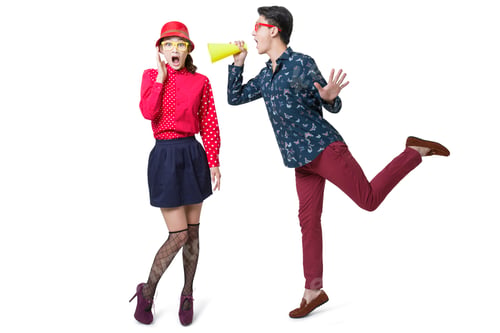 Preview: Young man shouting at woman through megaphones