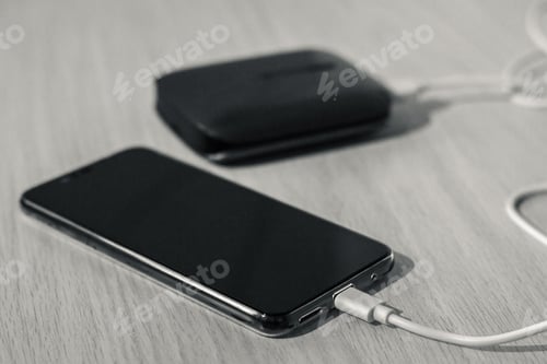 Preview: Charging your smartphone from a portable charger, close-up.