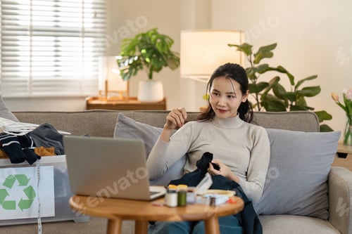 Preview: Woman Engaged in Sustainable Living by Recycling Clothes at Home, Promoting Eco-Friendly Practices