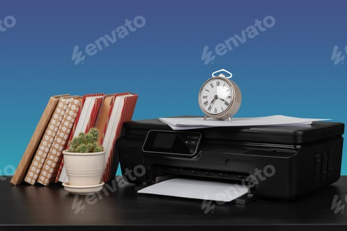 Preview: Compact laser printer on black desk against blue background