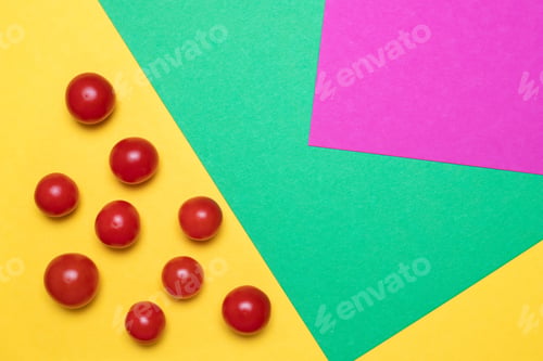Preview: Colorful pattern of red tomatoes on green and yellow background. From top view