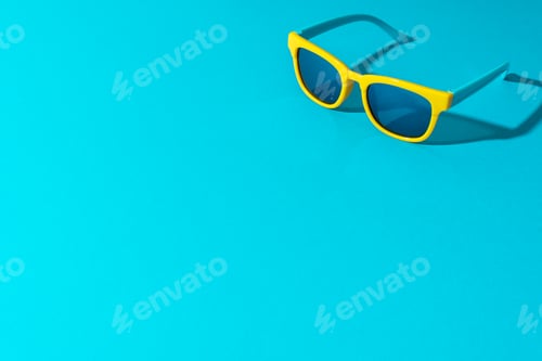 Preview: Minimalist Photo Of Sunglasses On Turquoise Blue Background With Copy Space