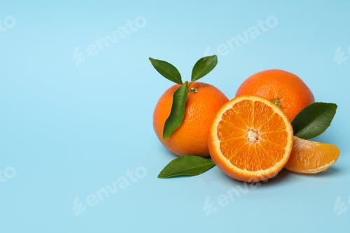 Preview: Ripe sweet mandarins on blue background, space for text