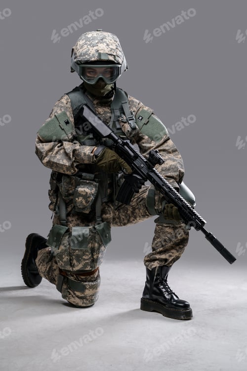 Preview: Modern servicewoman with rifle sitting against grey background