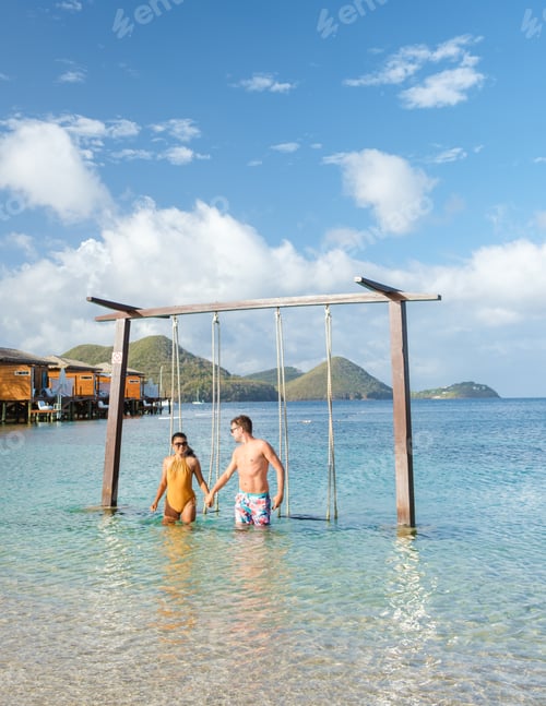 Preview: Couple in a swing on the beach of the tropical Island Saint Lucia or St Lucia Caribbean