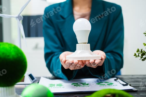 Preview: An Asian businesswoman sits at her desk, discussing clean energy solutions their impact on homes