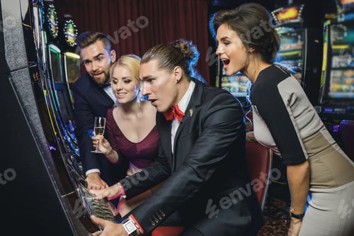 Preview: Group of friends playing slot machines in casino