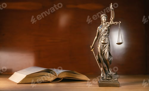Preview: Statue of lady justice and a book on a brown background copy space for text