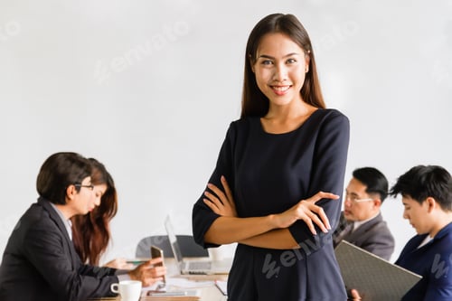 Preview: Portrait of happy asian businesswoman with her team at the office.