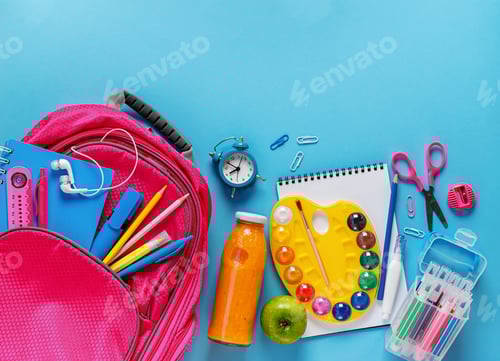 Preview: Pink backpack, fruit smoothie bottle,and stationery on blue background. Top view, copy space.