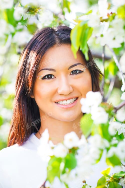 Preview: Happy smiling young girl in spring garden