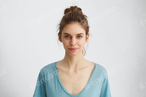Preview: Young Woman Posing Against a White Background
