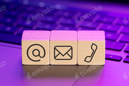 Preview: Contact us icons on wooden blocks on laptop with colorful lights
