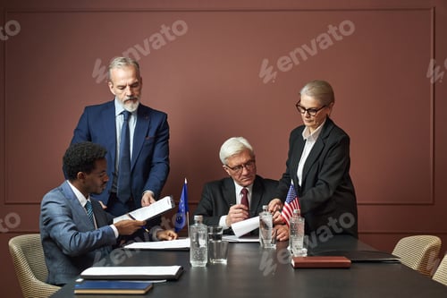 Preview: Diverse Group of Middle Aged Politicians Signing International Agreement