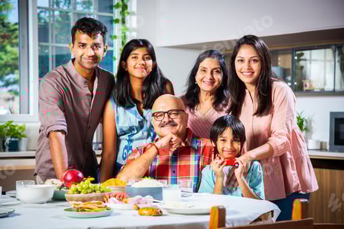 Preview: Happy Indian asian family having lunch at home and posing for photo